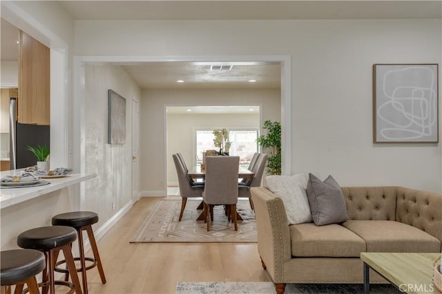 dining space with recessed lighting, visible vents, light wood finished floors, and baseboards