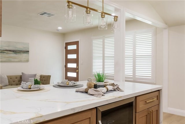 interior space featuring visible vents, light wood finished floors, and wine cooler