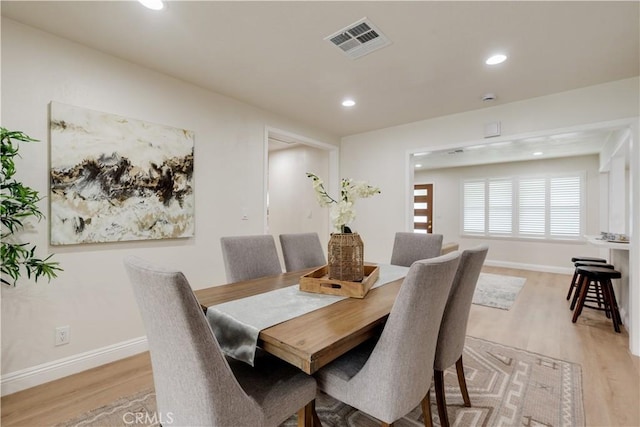 dining area with baseboards, light wood-style flooring, visible vents, and recessed lighting