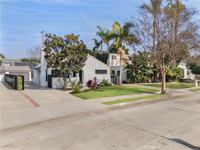 view of front of house with stucco siding and a front yard