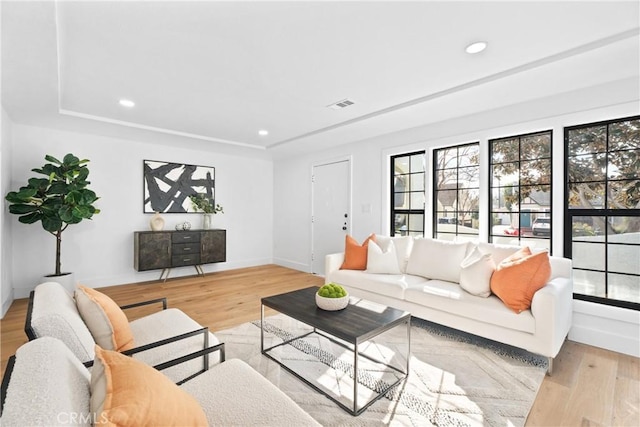living room with light wood-style flooring, visible vents, recessed lighting, and a healthy amount of sunlight
