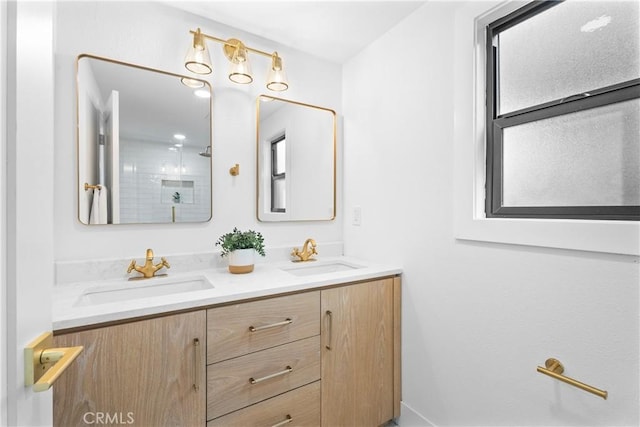 bathroom with walk in shower, a sink, and double vanity