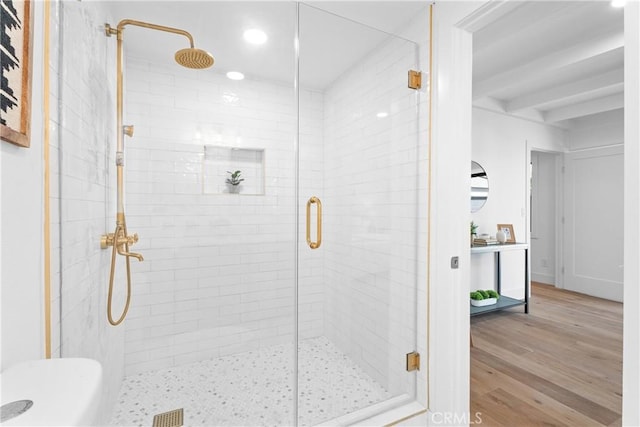 full bath featuring beamed ceiling, wood finished floors, a stall shower, and recessed lighting