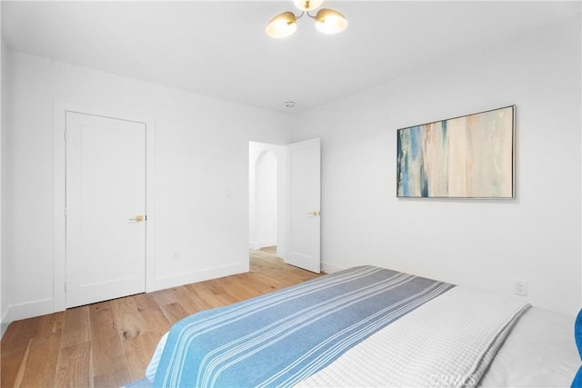 unfurnished bedroom with wood finished floors and baseboards