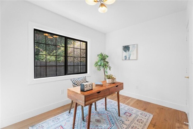 home office with light wood-style floors and baseboards