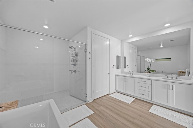 3713 Rivington, Irvine, CA 92612 - full bath with a sink, double vanity, recessed lighting, a shower stall, and wood finished floors