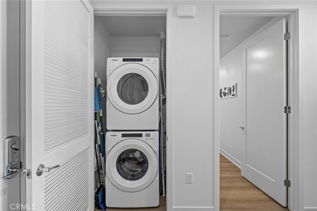 3713 Rivington, Irvine, CA 92612 - laundry room featuring stacked washer / drying machine, wood finished floors, and laundry area