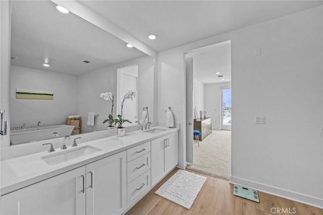 3713 Rivington, Irvine, CA 92612 - bathroom with recessed lighting, a sink, wood finished floors, and double vanity