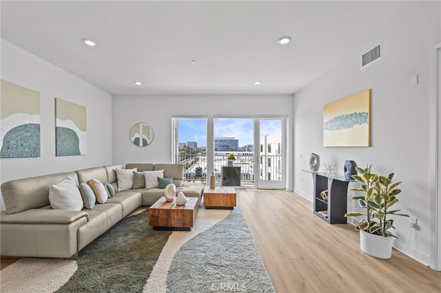 3713 Rivington, Irvine, CA 92612 - living area featuring visible vents, wood finished floors, baseboards, a city view, and recessed lighting