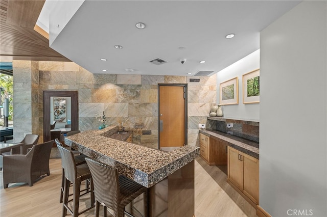 3713 Rivington, Irvine, CA 92612 - kitchen with a kitchen breakfast bar, visible vents, dark countertops, recessed lighting, and light wood-style flooring