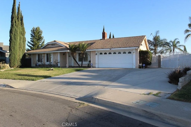 645 W James St, Rialto, CA 92376 - ranch-style house with a chimney, a gate, driveway, a front yard, and a garage