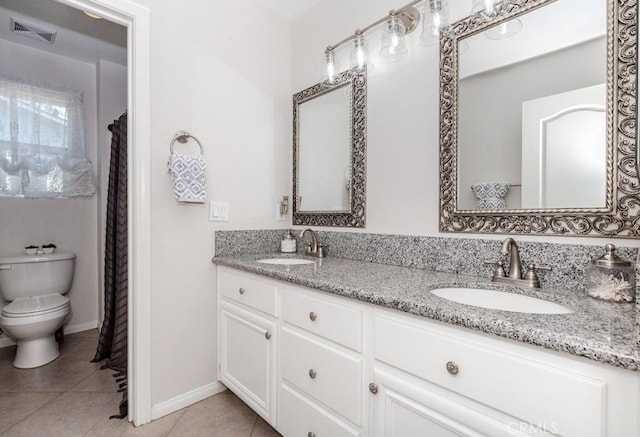 7607 Corona Valley Ave, Eastvale, CA 92880 - full bath featuring double vanity, toilet, tile patterned floors, and baseboards