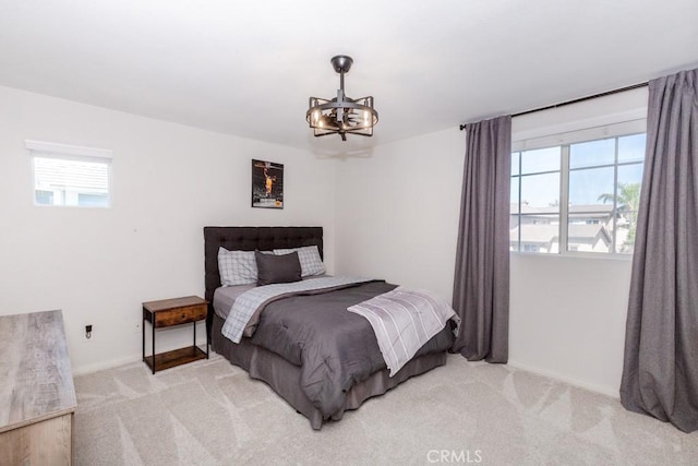 7607 Corona Valley Ave, Eastvale, CA 92880 - bedroom with a chandelier, light carpet, and baseboards