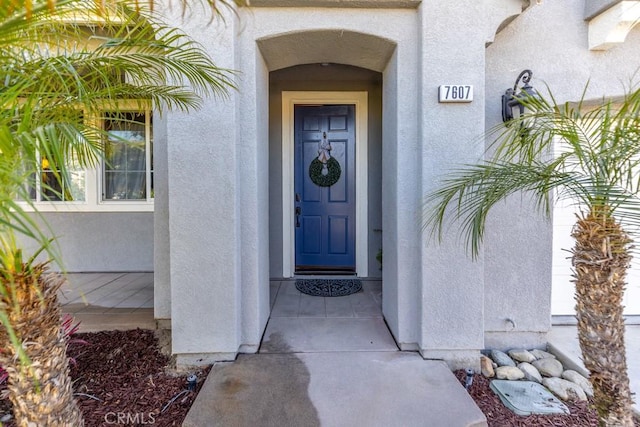7607 Corona Valley Ave, Eastvale, CA 92880 - doorway to property with stucco siding