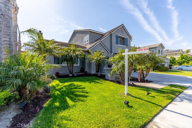 7607 Corona Valley Ave, Eastvale, CA 92880 - view of front of house with concrete driveway, stucco siding, a front lawn, and a garage