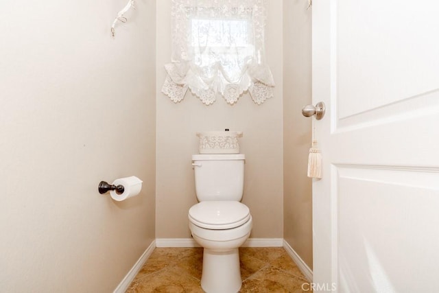 7607 Corona Valley Ave, Eastvale, CA 92880 - bathroom with toilet, baseboards, and tile patterned floors
