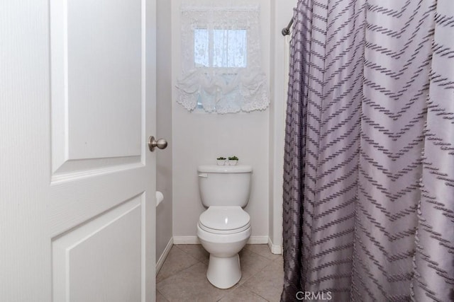 7607 Corona Valley Ave, Eastvale, CA 92880 - bathroom featuring toilet, tile patterned floors, baseboards, and a shower with shower curtain