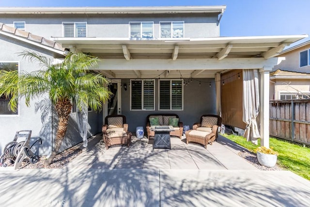7607 Corona Valley Ave, Eastvale, CA 92880 - back of property featuring an outdoor living space with a fire pit, stucco siding, and a patio