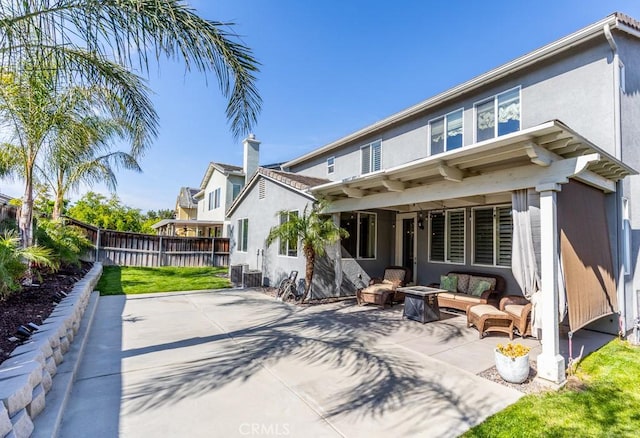 7607 Corona Valley Ave, Eastvale, CA 92880 - rear view of property featuring a patio area, an outdoor hangout area, stucco siding, and central AC