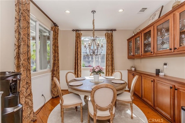 7607 Corona Valley Ave, Eastvale, CA 92880 - dining space with a chandelier, a wainscoted wall, light wood-style flooring, and recessed lighting