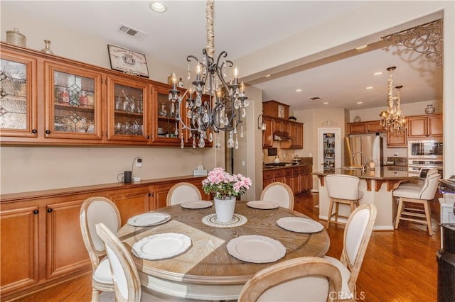 7607 Corona Valley Ave, Eastvale, CA 92880 - dining space with a chandelier, light wood-style floors, and recessed lighting