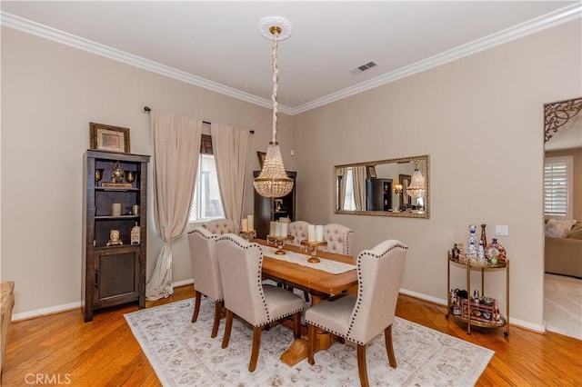 7607 Corona Valley Ave, Eastvale, CA 92880 - dining space featuring ornamental molding, wood finished floors, baseboards, and a chandelier