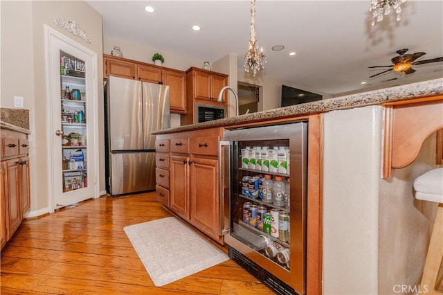 7607 Corona Valley Ave, Eastvale, CA 92880 - kitchen featuring freestanding refrigerator, light wood finished floors, recessed lighting, beverage cooler, and ceiling fan