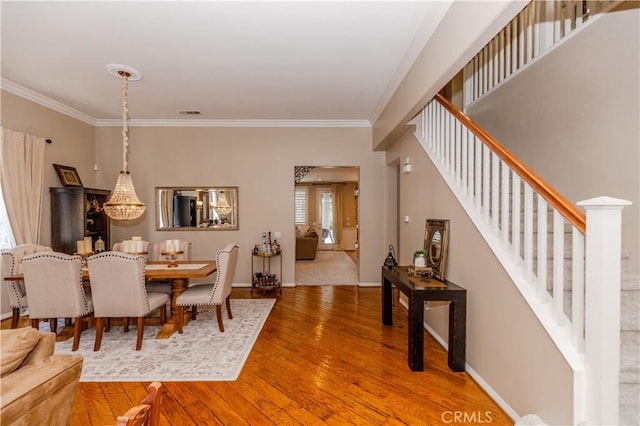7607 Corona Valley Ave, Eastvale, CA 92880 - dining area featuring stairs, ornamental molding, wood finished floors, and baseboards
