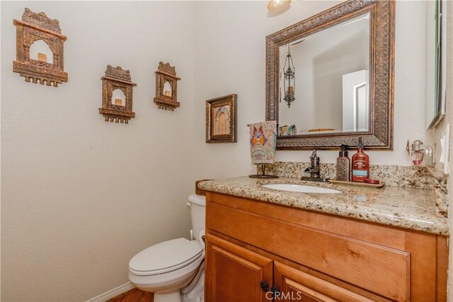 7607 Corona Valley Ave, Eastvale, CA 92880 - bathroom with vanity, toilet, and baseboards