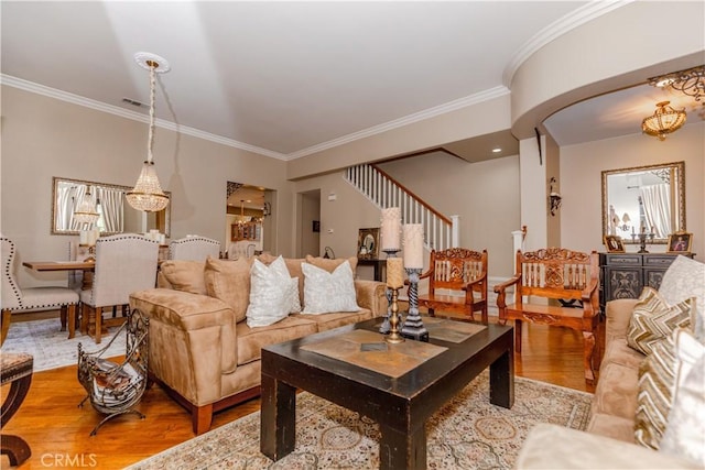 7607 Corona Valley Ave, Eastvale, CA 92880 - living area featuring wood finished floors, ornamental molding, a chandelier, and stairway