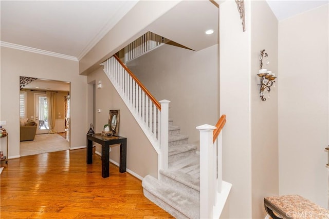 7607 Corona Valley Ave, Eastvale, CA 92880 - stairway featuring crown molding, wood finished floors, baseboards, and recessed lighting