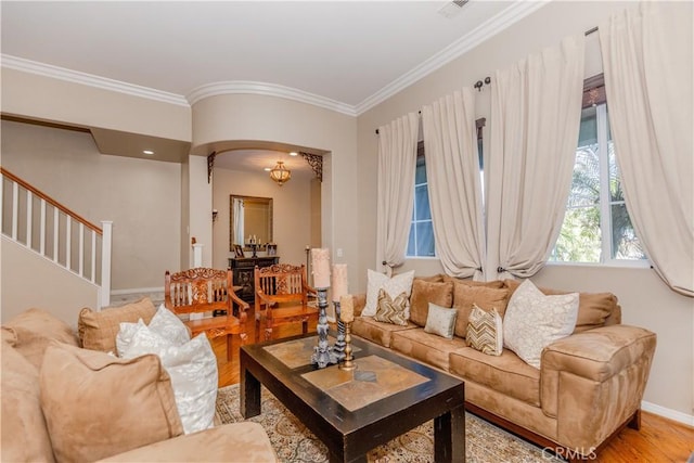 7607 Corona Valley Ave, Eastvale, CA 92880 - living room featuring ornamental molding, stairs, arched walkways, baseboards, and wood finished floors