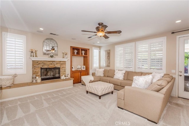 7607 Corona Valley Ave, Eastvale, CA 92880 - living area with plenty of natural light, a stone fireplace, ceiling fan, carpet, and recessed lighting
