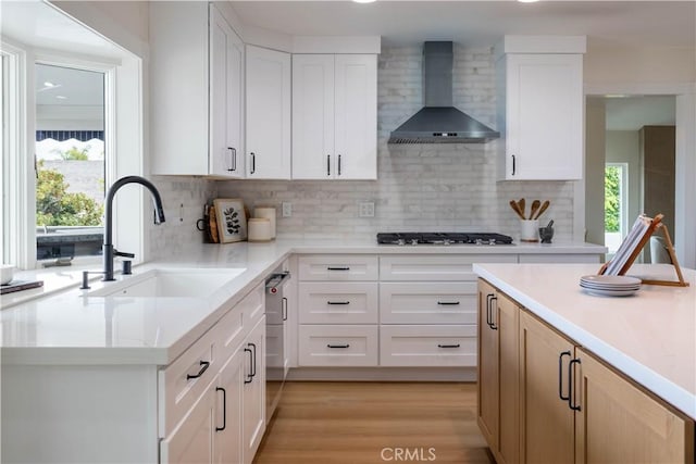 3802 E Summitridge Ln, Orange, CA 92867 - kitchen with wall chimney range hood, gas cooktop, decorative backsplash, a sink, and light countertops
