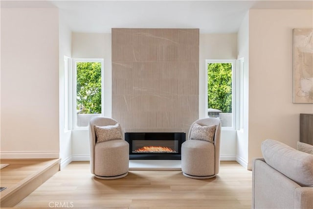 3802 E Summitridge Ln, Orange, CA 92867 - living area with a glass covered fireplace, baseboards, plenty of natural light, and wood finished floors