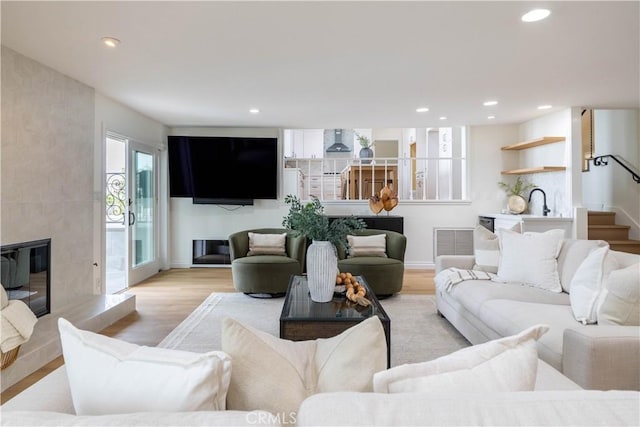 3802 E Summitridge Ln, Orange, CA 92867 - living room with recessed lighting, a fireplace, light wood finished floors, and stairs