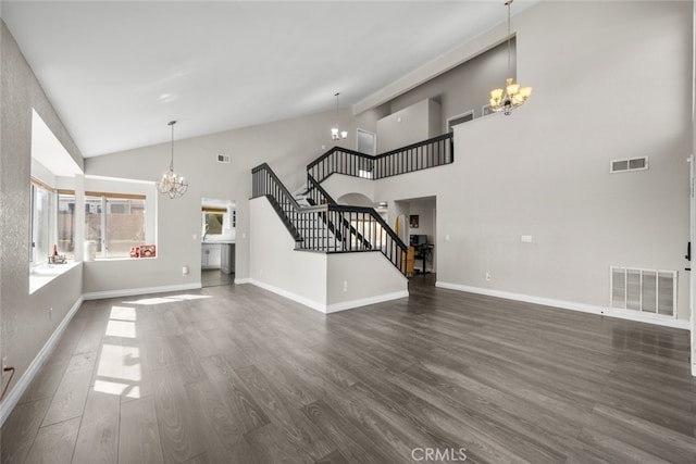 unfurnished living room with stairway, a notable chandelier, and visible vents