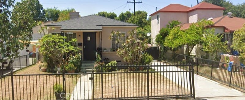bungalow featuring fence, a chimney, a gate, and stucco siding
