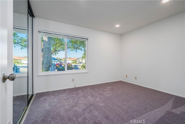 carpeted empty room featuring recessed lighting, plenty of natural light, and baseboards