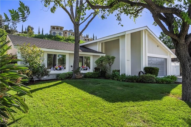 view of front facade with an attached garage and a front lawn