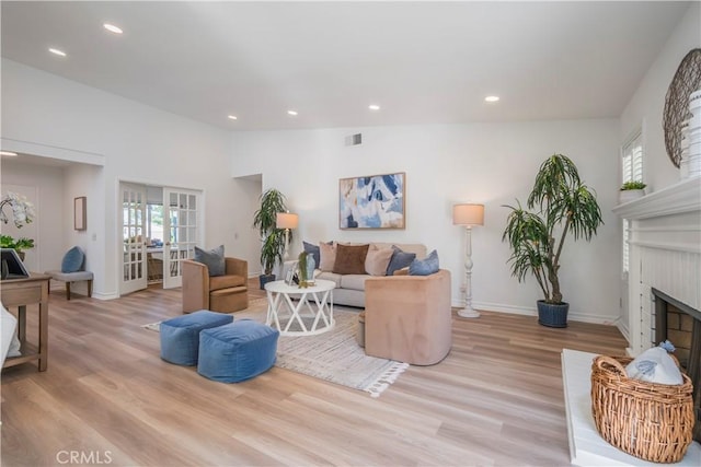 living area with recessed lighting, wood finished floors, visible vents, and plenty of natural light