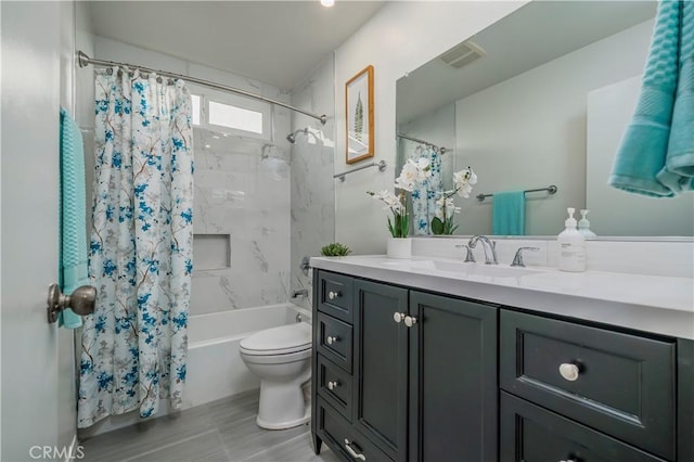 bathroom featuring shower / tub combo, visible vents, vanity, and toilet