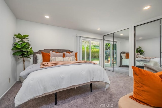 bedroom with recessed lighting, carpet floors, and multiple closets