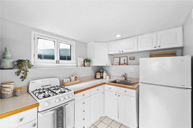 1056 Glenneyre St, Laguna Beach, CA 92651 - kitchen with light countertops, white cabinetry, a sink, and white appliances