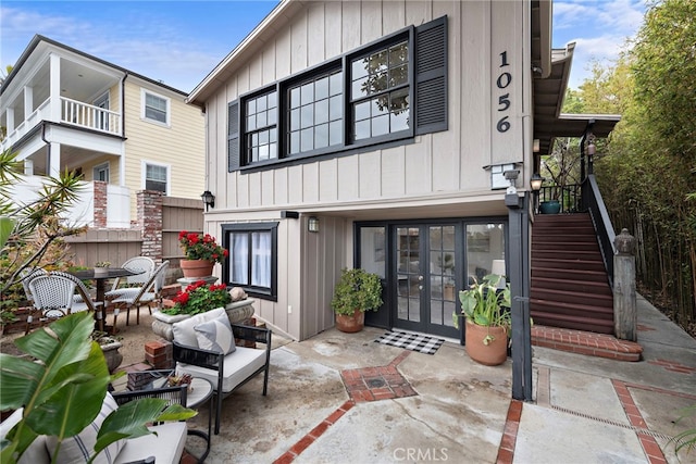 1056 Glenneyre St, Laguna Beach, CA 92651 - back of house featuring board and batten siding, a patio area, stairs, and french doors