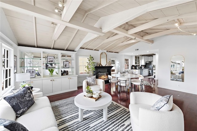 1056 Glenneyre St, Laguna Beach, CA 92651 - living area with lofted ceiling with beams, a glass covered fireplace, wooden ceiling, dark wood finished floors, and baseboards