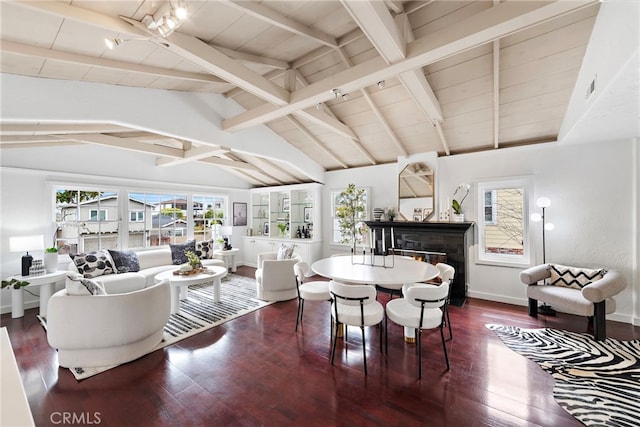 1056 Glenneyre St, Laguna Beach, CA 92651 - dining room with lofted ceiling with beams, baseboards, a glass covered fireplace, and wood finished floors