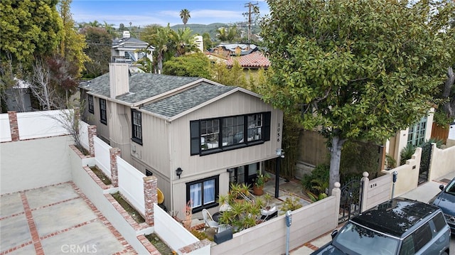 1056 Glenneyre St, Laguna Beach, CA 92651 - view of home's exterior with a shingled roof and a fenced backyard