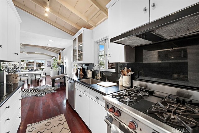 1056 Glenneyre St, Laguna Beach, CA 92651 - kitchen featuring a sink, dark countertops, vaulted ceiling with beams, under cabinet range hood, and appliances with stainless steel finishes