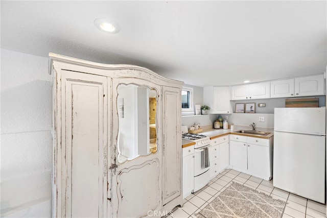 1056 Glenneyre St, Laguna Beach, CA 92651 - kitchen with a sink, white appliances, light tile patterned floors, light countertops, and white cabinetry